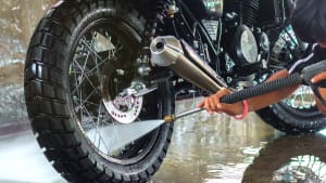 Mann wäscht Motorrad