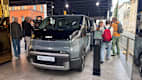 Ein Kia PV5 steht auf der IAA 2025 in München. Das Auto ist von vorne zu sehen, mit einem eleganten und aerodynamischen Design. Die Frontpartie hat einen geschlossenen Kühlergrill und schmale LED-Scheinwerfer.