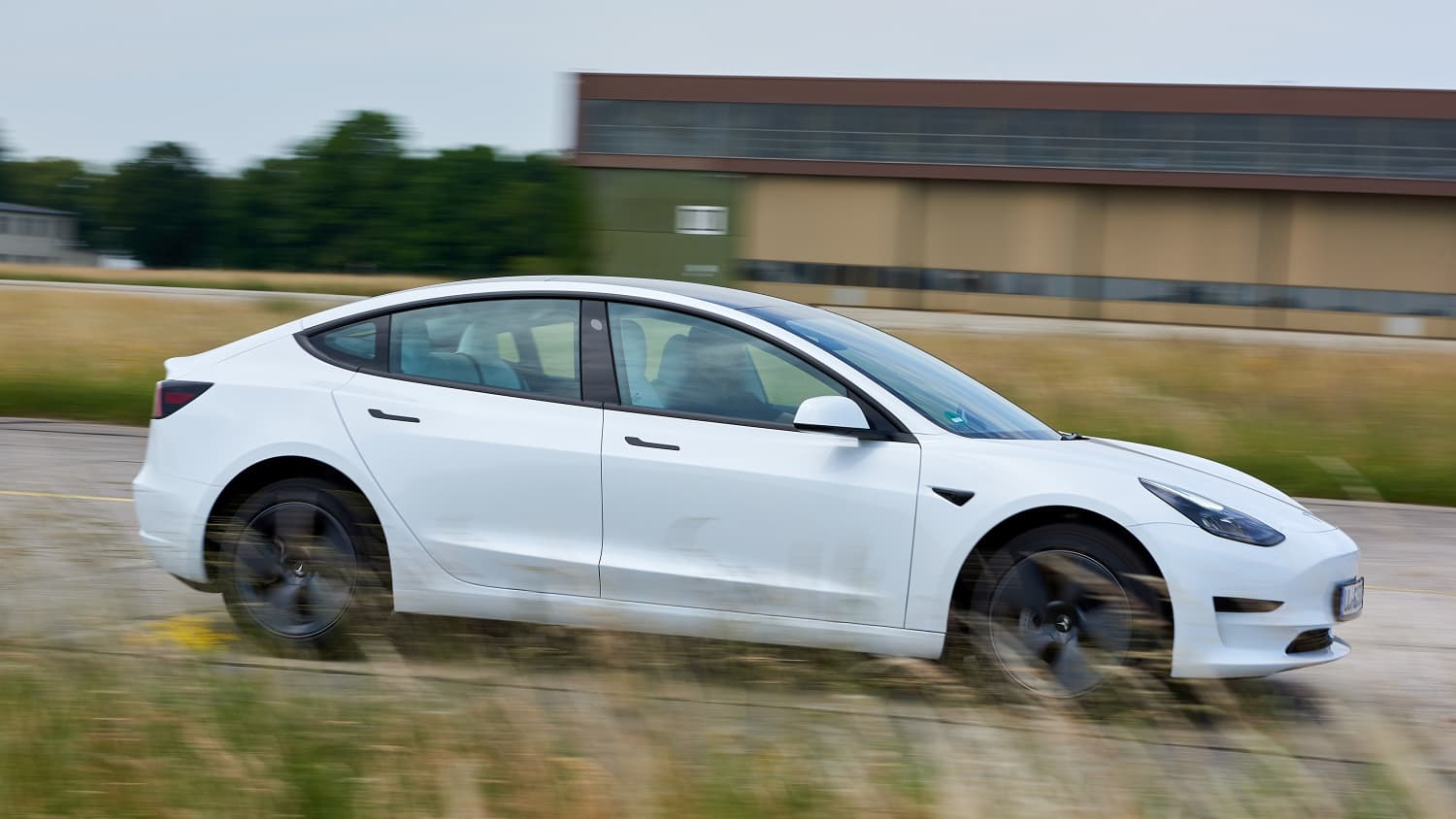 Tesla Model 3 fahrend von der Seite