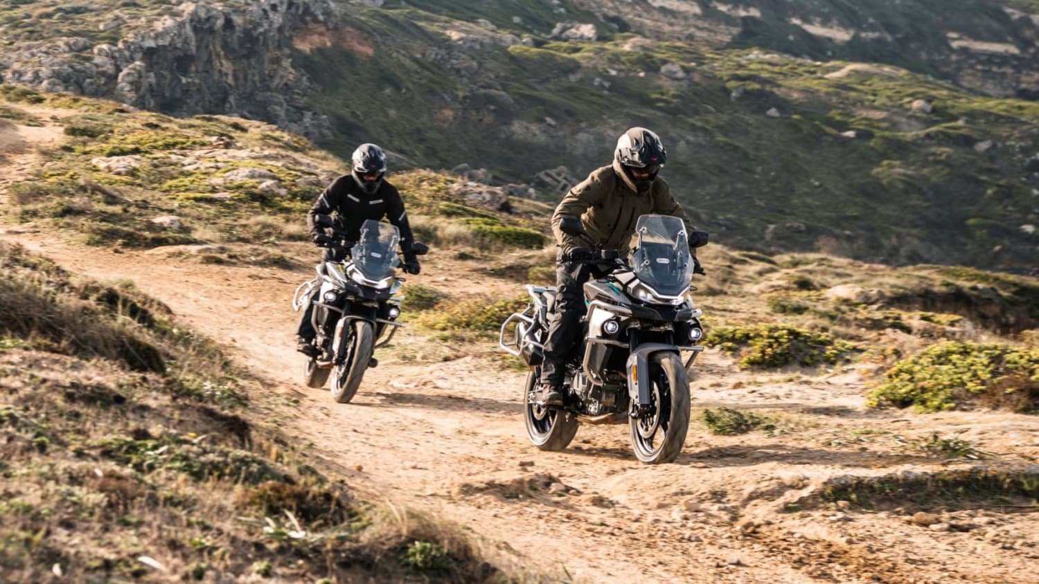 Eine CF Moto 800MT Touring fährt auf einem Gelände