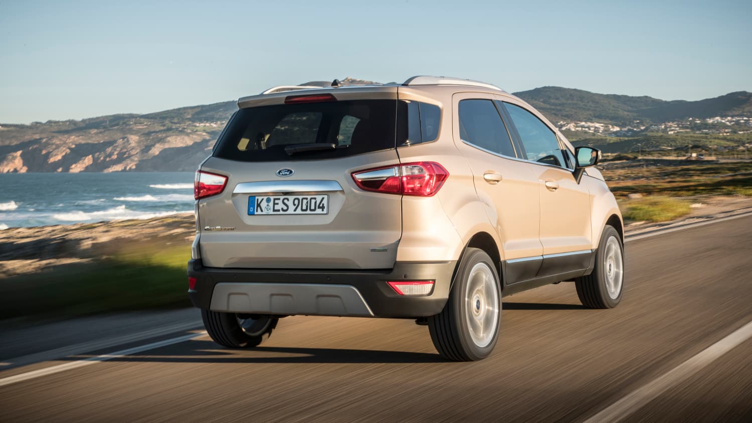 Beiger Ford EcoSport faehrt Kuestenstrasse entlang