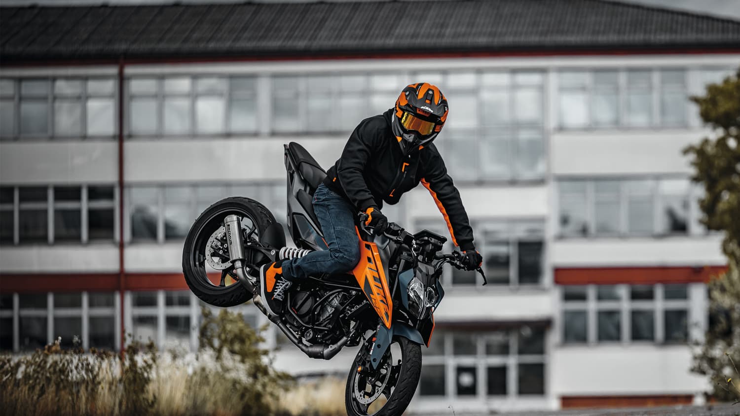 Ein Stuntman auf der KTM 125 Duke der ein Trick mit dem Motorrad macht
