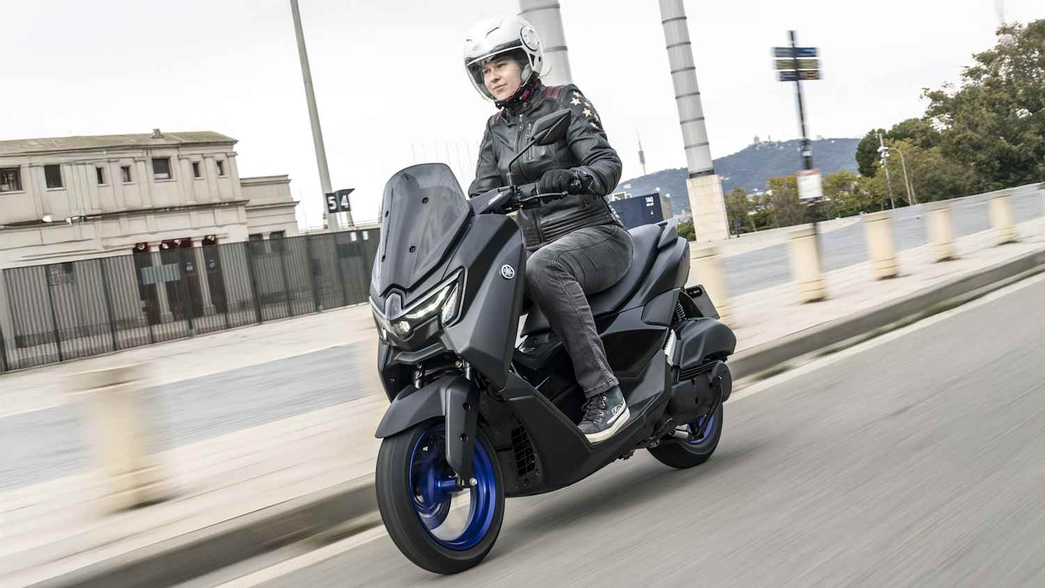Eine Frau fährt auf einer Yamaha NMAX 125