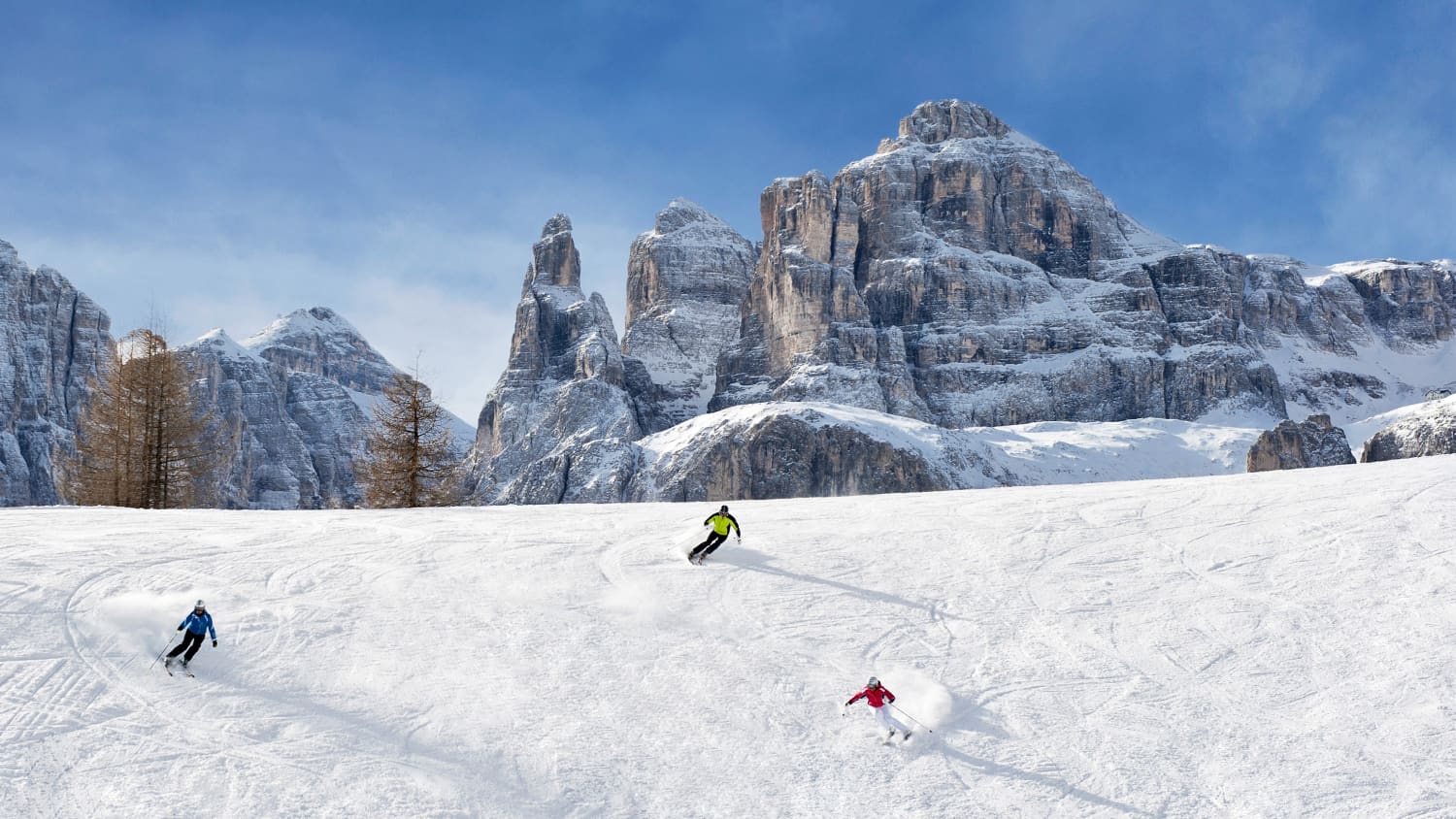 Skifahrer im Skigebiet Alta Badia vor den Drei Zinnen