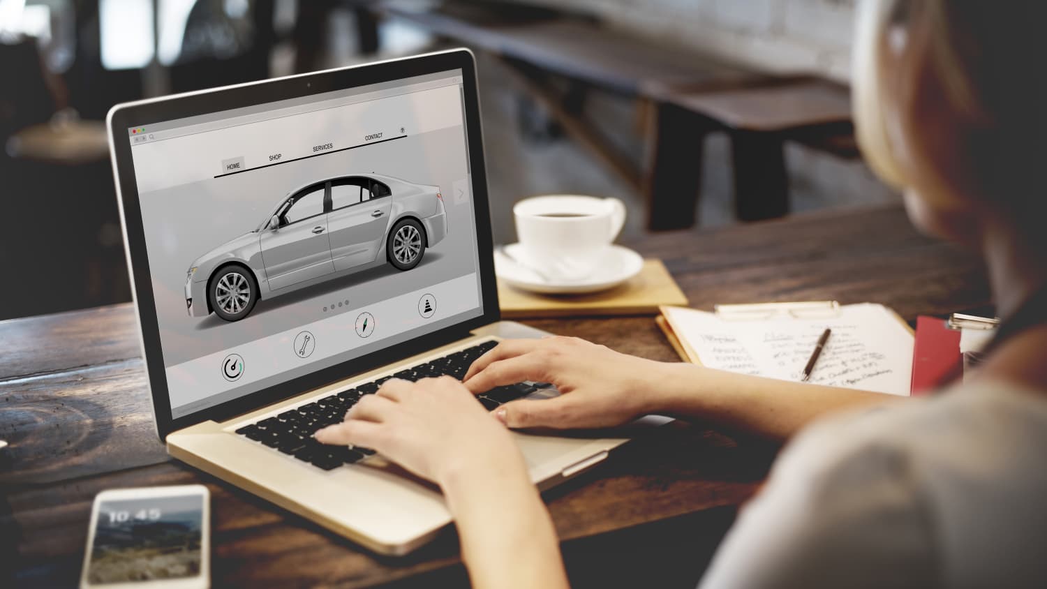 Frau informiert sich am Computer über Fahrzeugdaten zum Autokauf