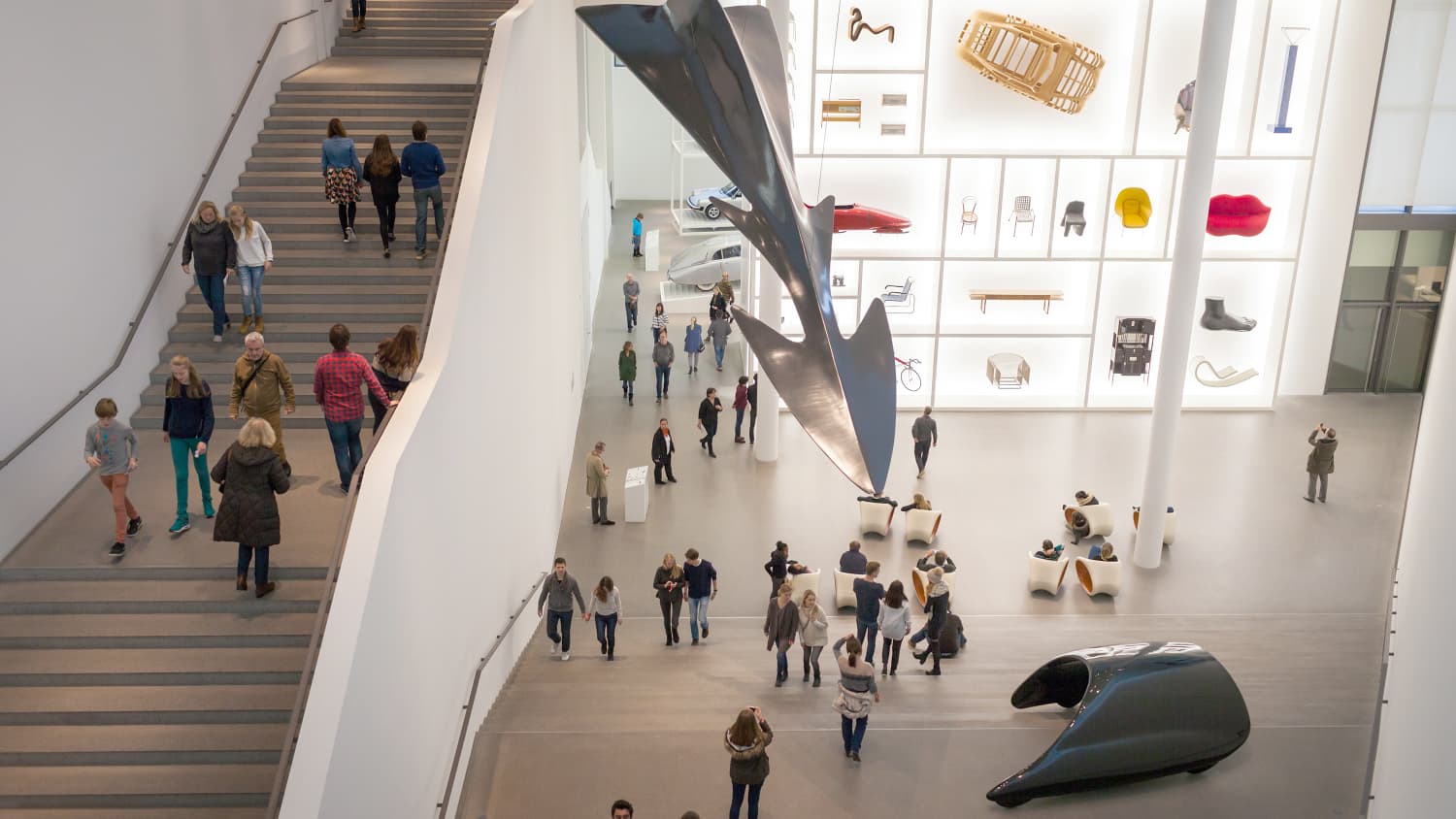 Das Kunstmuseum Pinakothek der Moderne in München von innen, mit Besuchern in der Ausstellungshalle