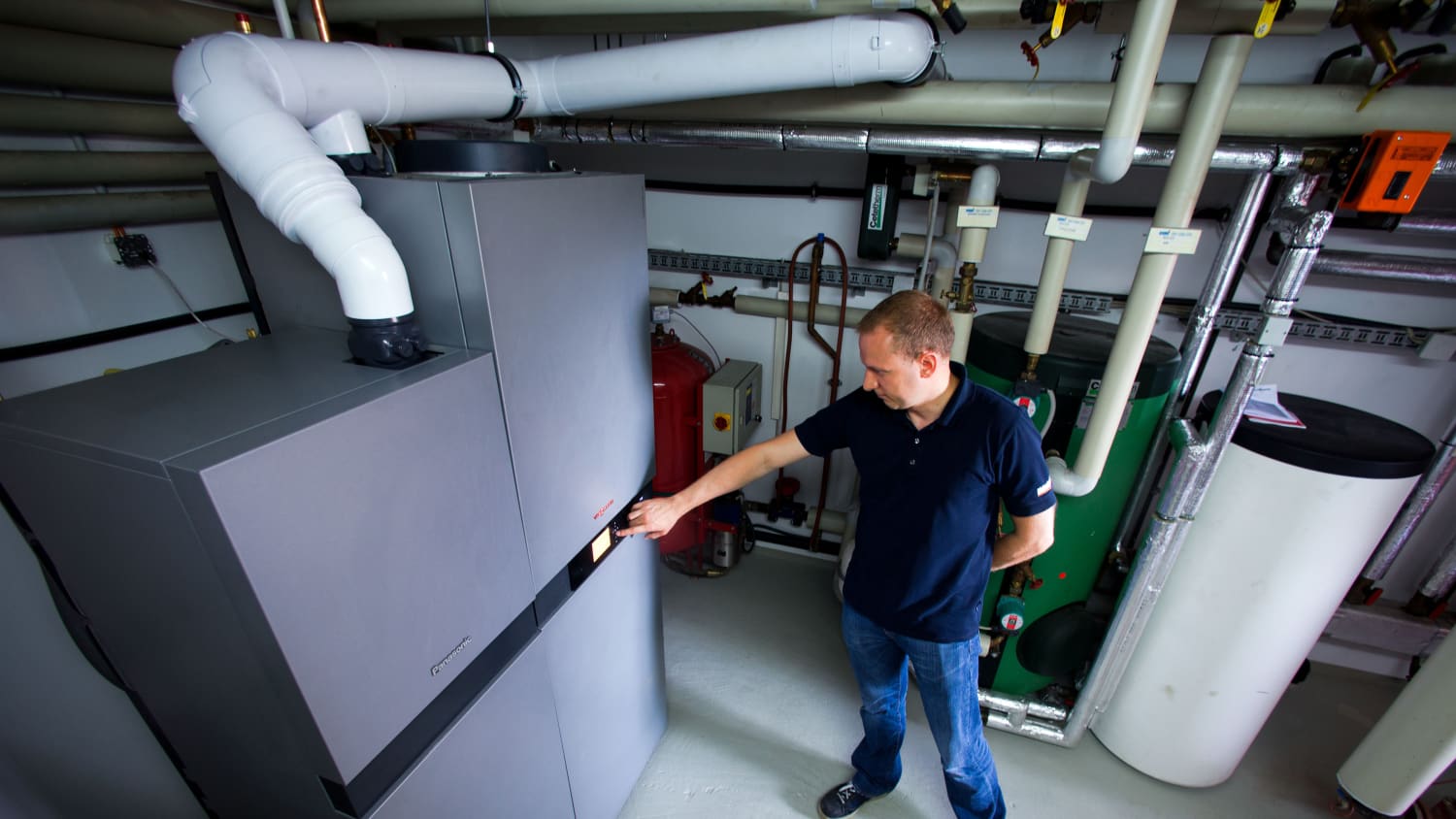 Ein Techniker steht vor einer Brennstoffzellen-Heizungsanlage