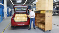 Ein ADAC Mitarbeiter misst das Volumen eines Kofferraumes anhand von Schaumstoffwürfeln.