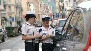 Zwei italienische Politessen schreiben in Bozen einen Strafzettel für ein parkendes Auto