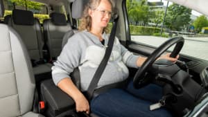 Eine Schwangere Frau sitzt in einem Auto
