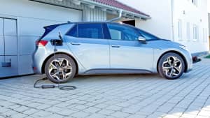 Ein Auto steht vor einem Haus mit einer mobile Wallbox