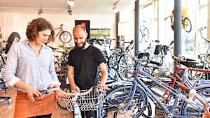 Eine Frau kauft ein Fahrrad in einem Fahrradladen