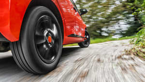 Nahaufnahme des Hinterreifen eines roten Autos