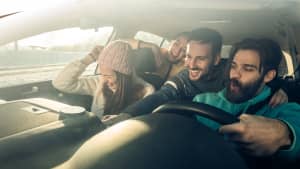 Junge Fahrer fahren zusammen im Auto