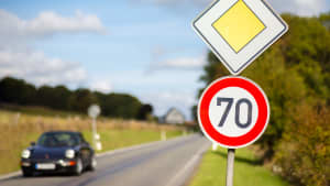 Ein Porsche fährt zu schnell auf einer Landstrasse bei Tempolimit 70