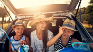 Drei Kinder vor Auto