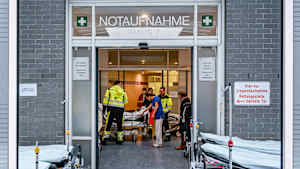 Sanitäter schieben eine Patientin in die Notaufnahme eines Krankenhauses