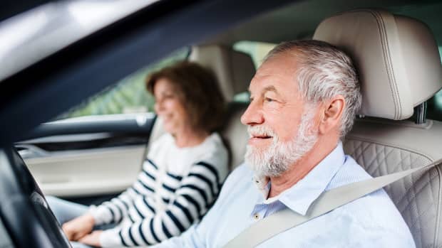 Ein älterer Mann sitzt am Steuer eines Autos