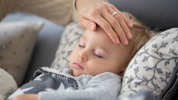Ein kleiner kranker Junge liegt im Bett