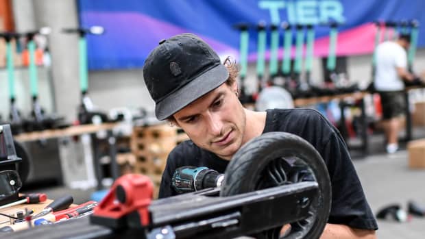 Mechaniker repariert E-Scooter