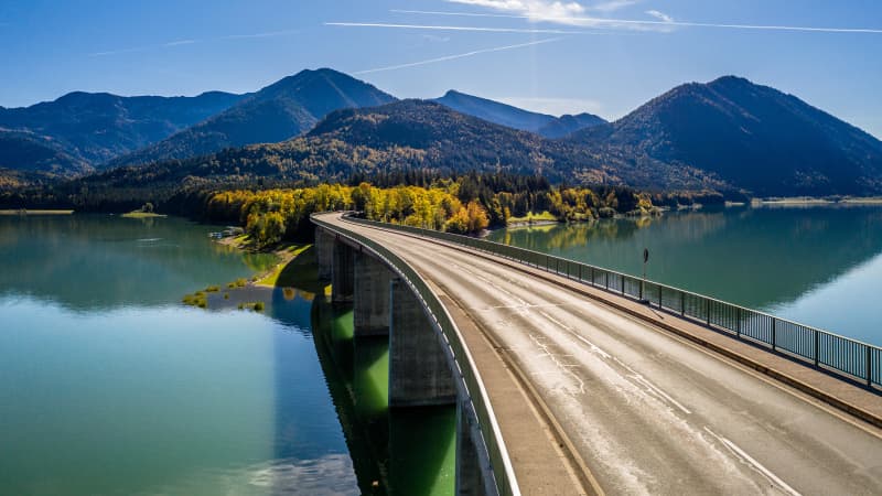 Der Sylvensteinspeicher in Bayern. Alpengebirge im Herbst und schöne Farbe des Wassers. Eine Brücke führt über den Stausee