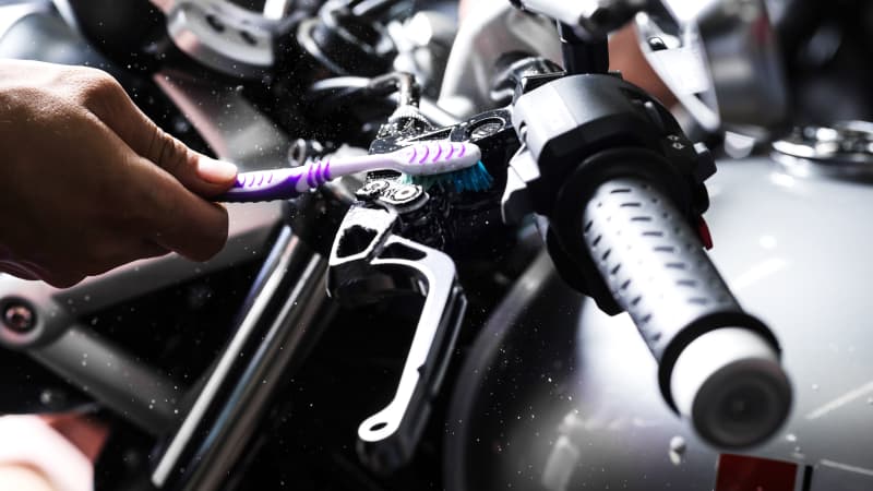 Motorrad wird mit Zahnbürste gereinigt