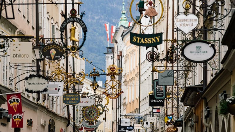 Blick auf die vielen historischen Aushängeschilder der Geschäfte in der Getreidegasse in Salzburg