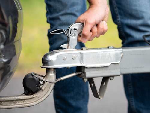 Transport-Anhänger wird am Pkw angekuppelt - Versicherung ADAC