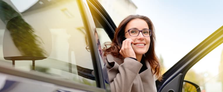 Frau sitzt im Auto und telefoniert - Verkehr Rechtsschutz ADAC